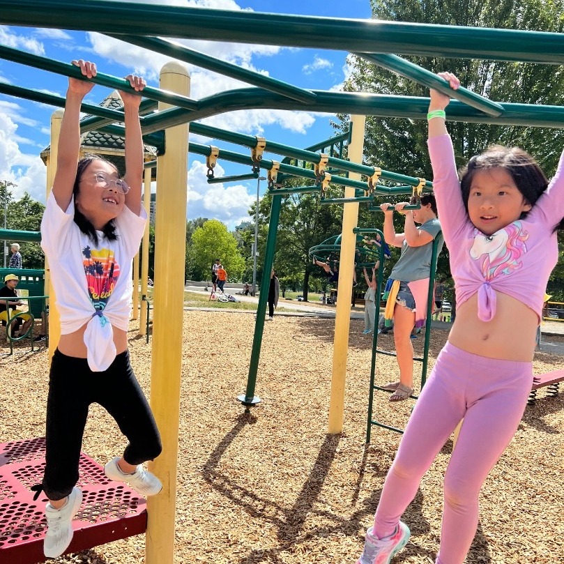 Kids at the playground hanging on monkey bars