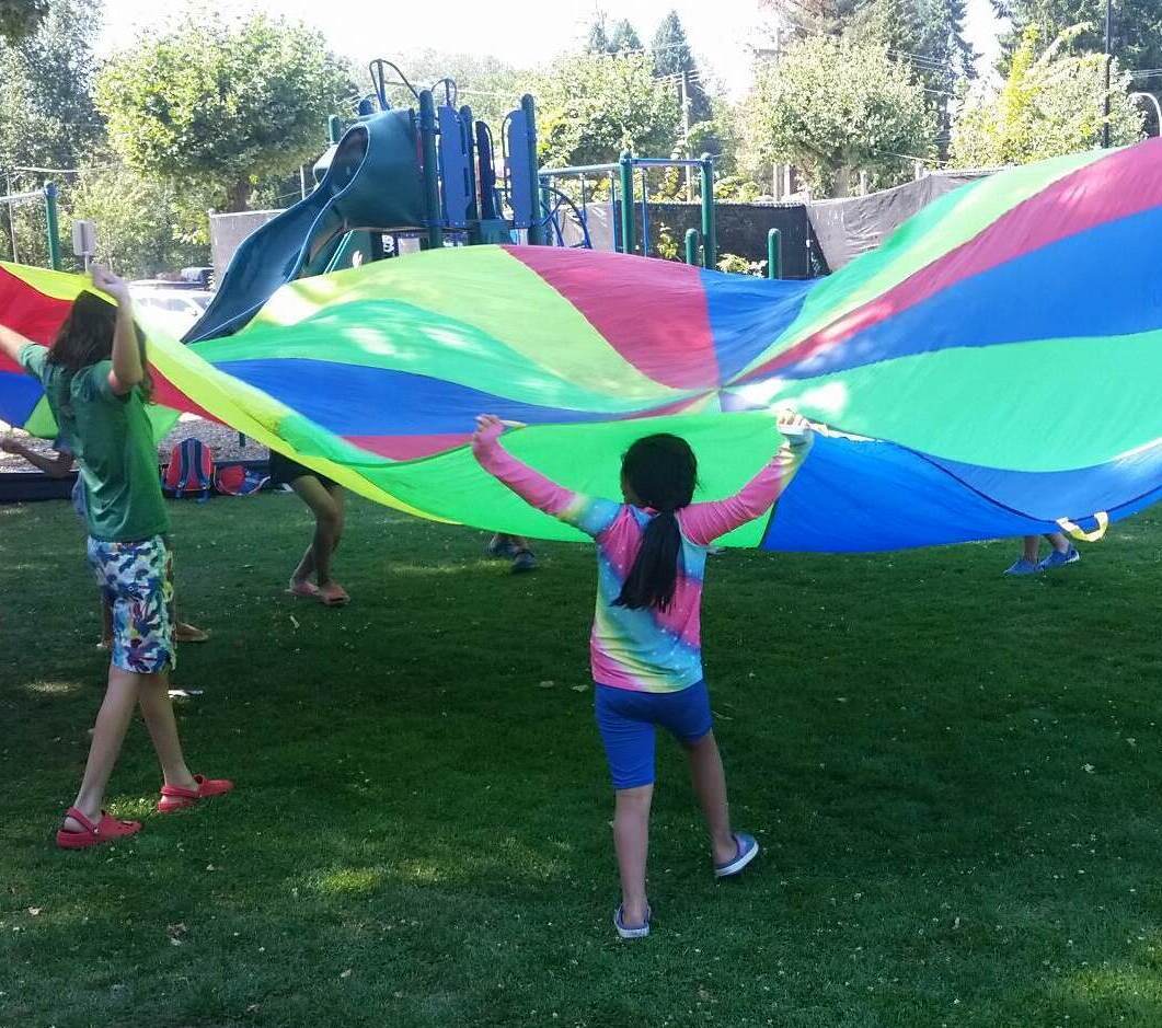 kids playing parachute games outdoors