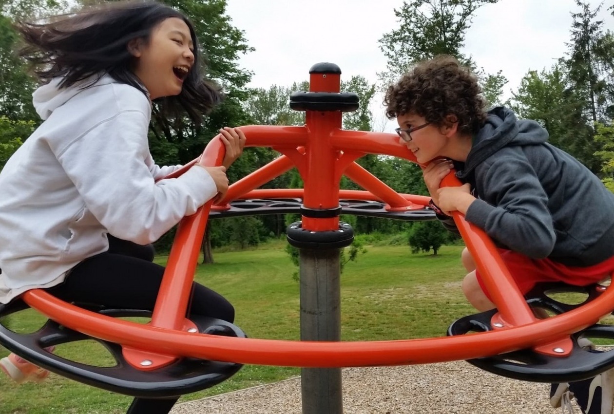 A girl and a boy having fun at the playground