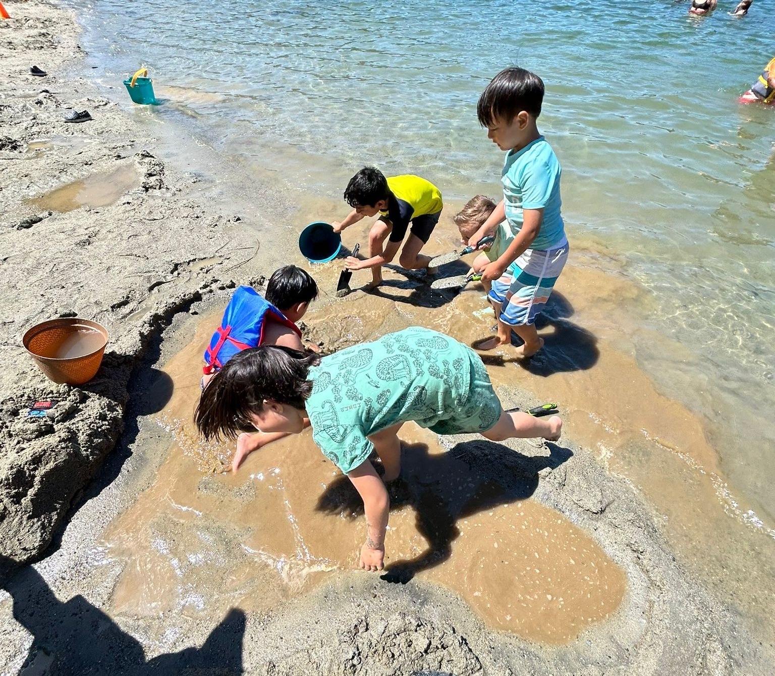 two campers holding sticks in the forest