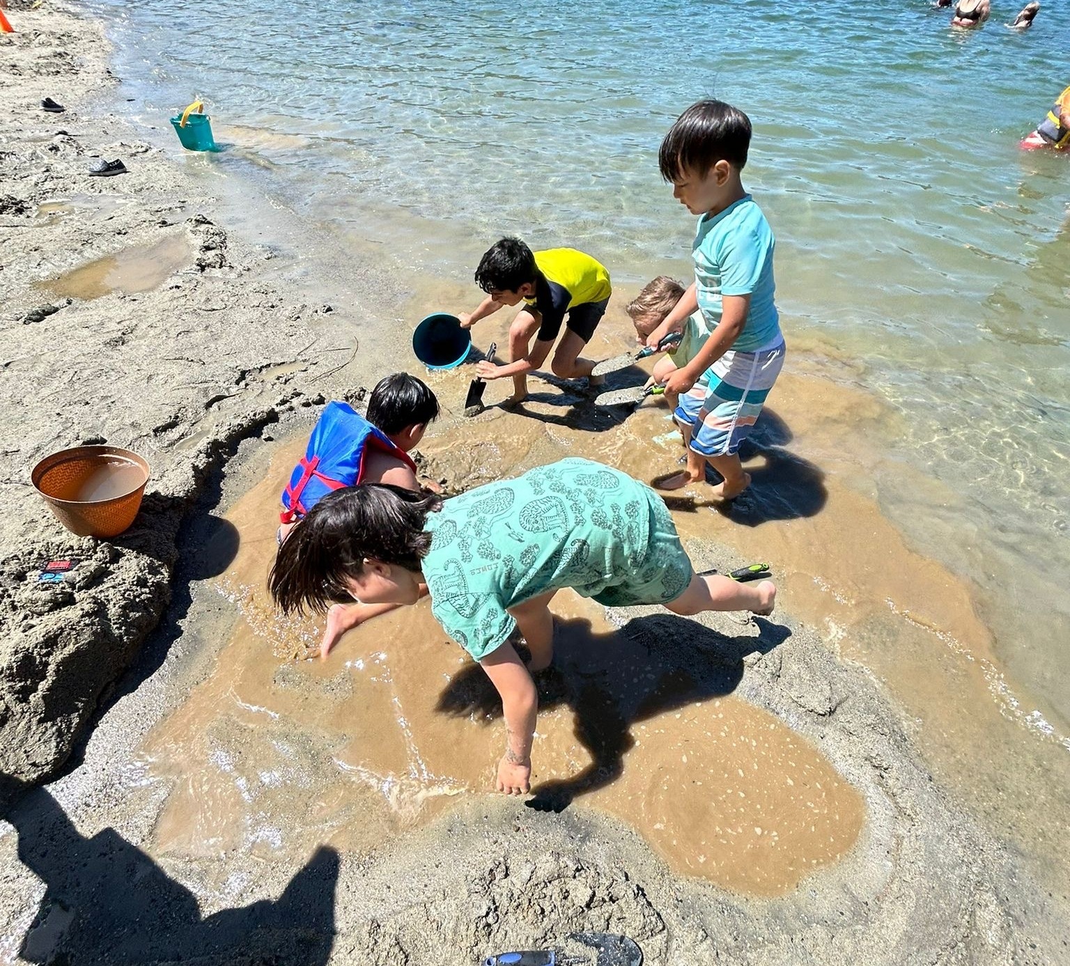 two campers holding sticks in the forest