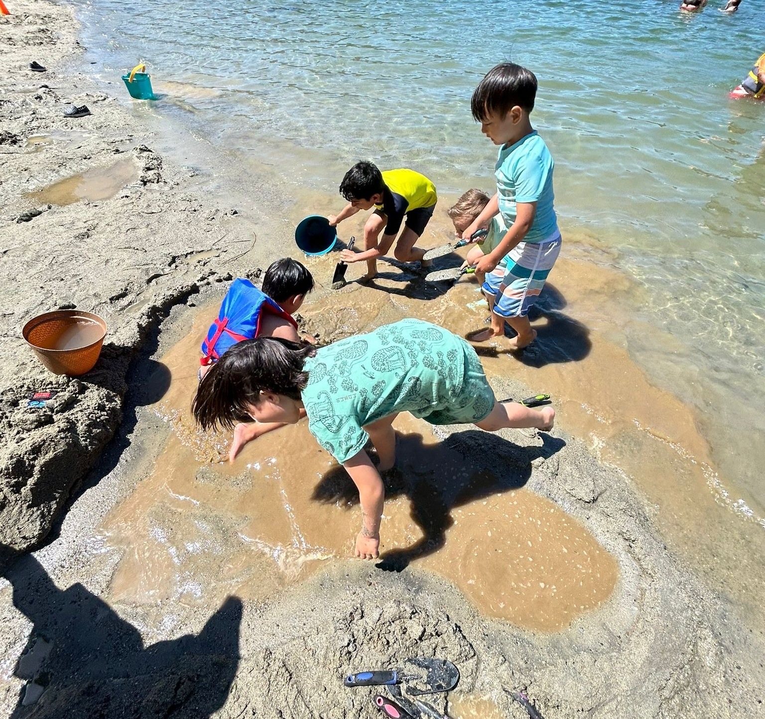 two smiling kids in the water at the beach