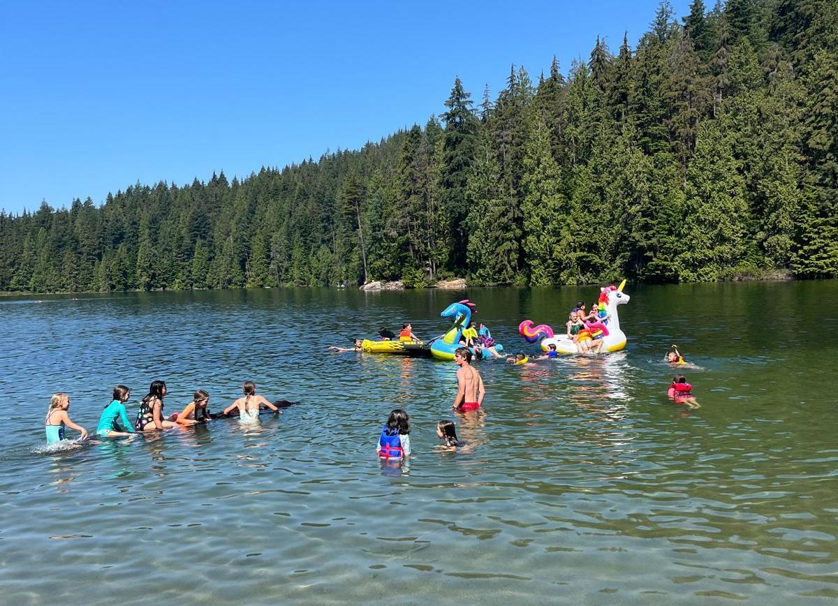 campers in the water at the beach