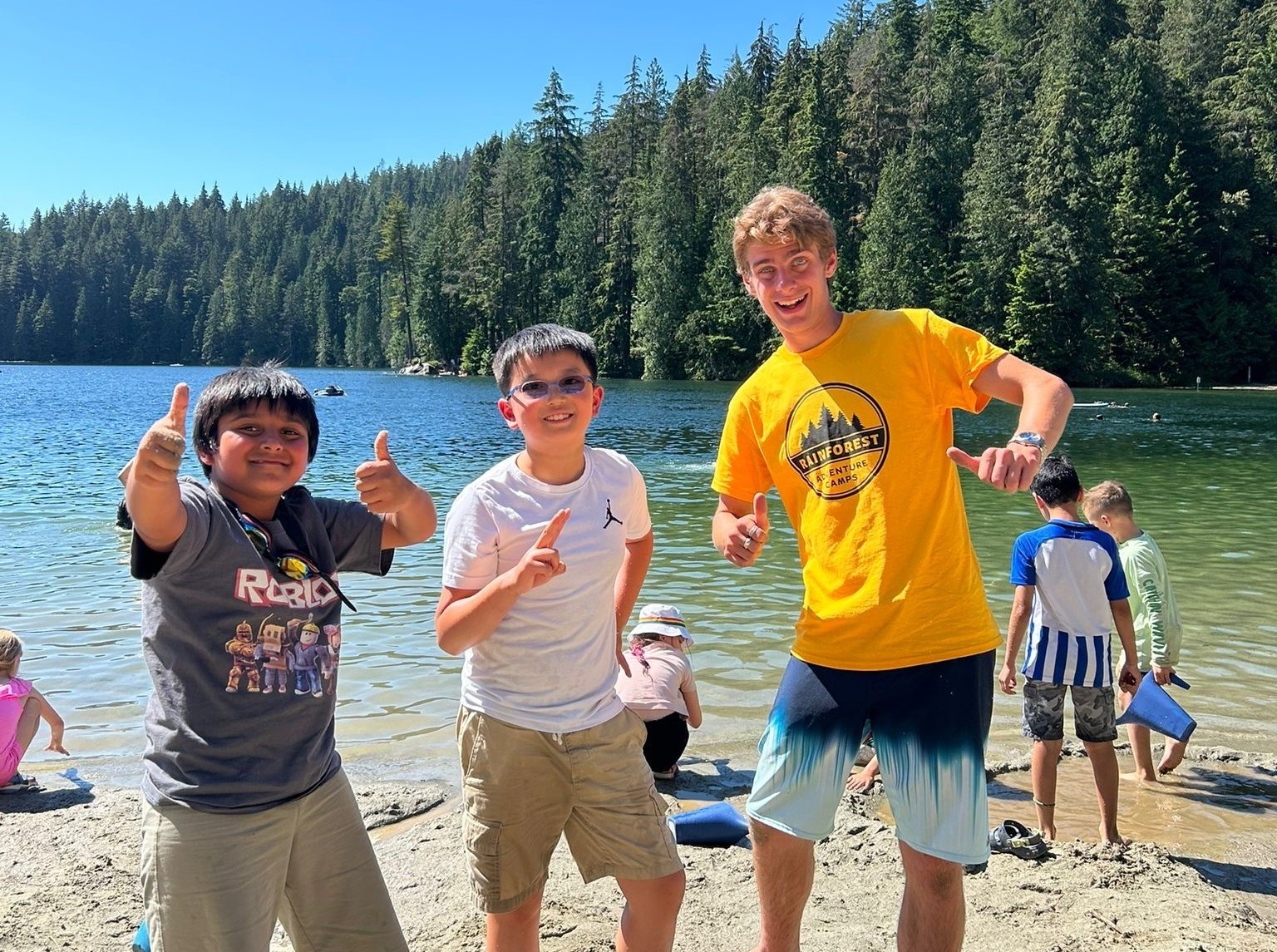 campers giving a thumbs up at the beach