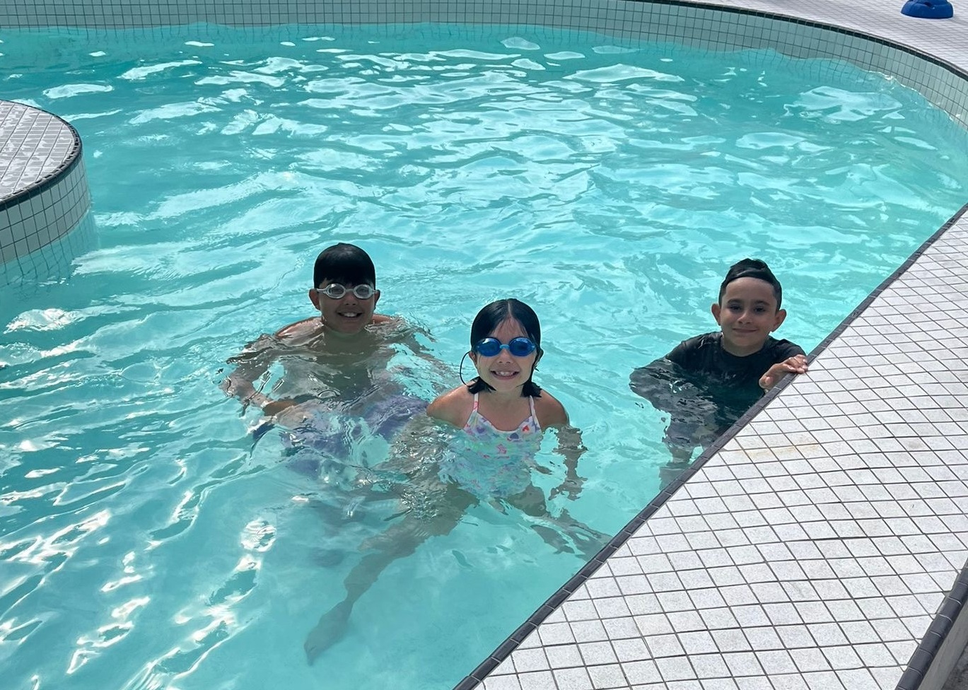 three campers at the swimming pool